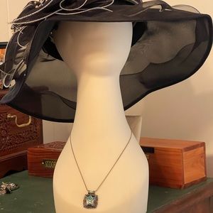 Aztec design necklace with turquoise on silver chain.